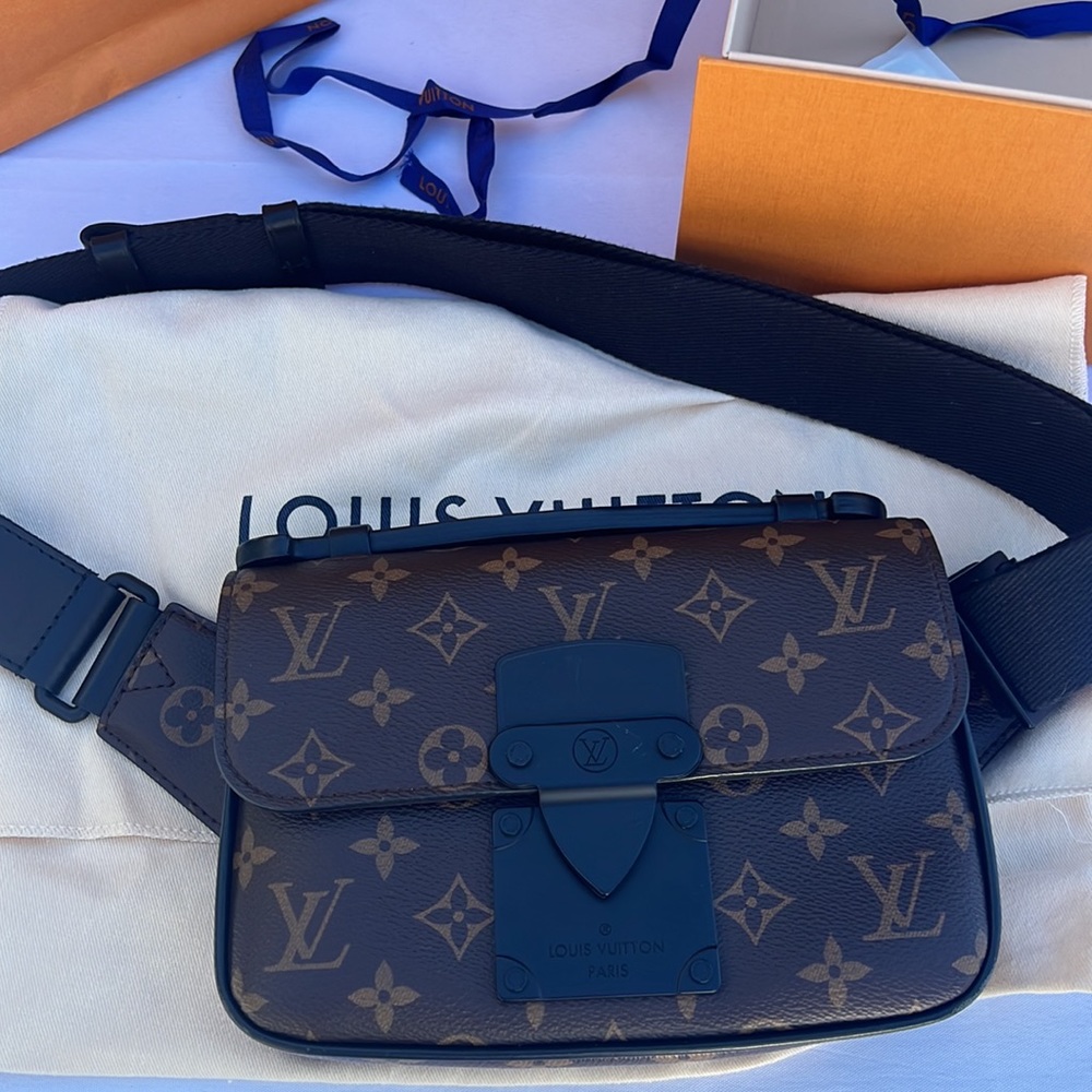 Louis Vuitton men’s cross body bag. S Lock -Sling. Neiman Marcus 2022.
